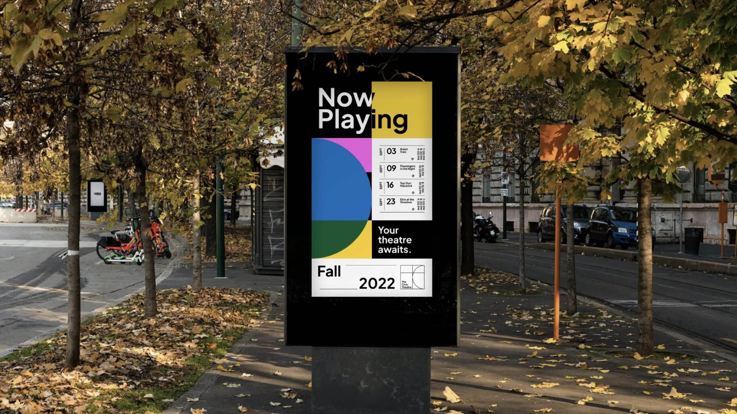 A digital billboard in a park showcases a vibrant pie chart design promoting the Nelson Civic Theatres program. The text reads Now Playing and Your theatre awaits, with Fall 2022 at the bottom. Autumn leaves and trees frame the inviting path.