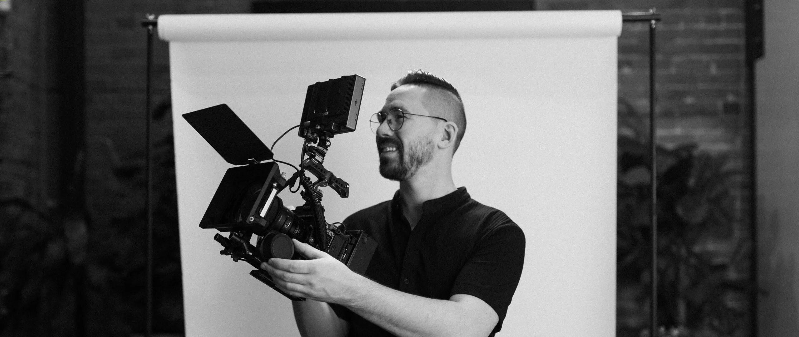 Mateo Allen, Managing Partner of Takt Studios poses with camera equipment