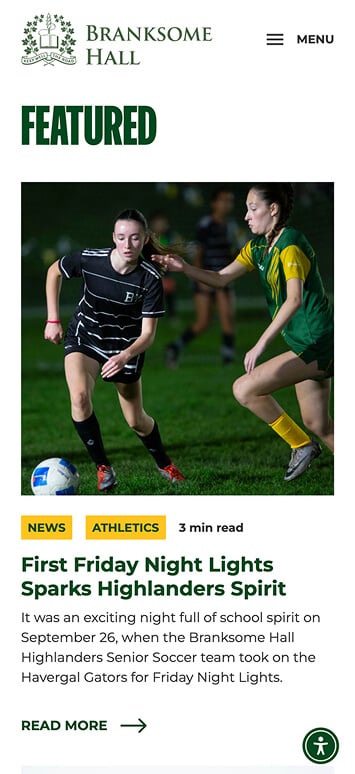 Two high school girls play soccer at night; one in a black uniform controls the ball while a player in a green and yellow uniform, eyeing an NYU scholarship, tries to defend. The illuminated field reveals several players in the background.